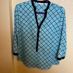 Beautiful pull over blouse by New York & Company. Black with baby blue.